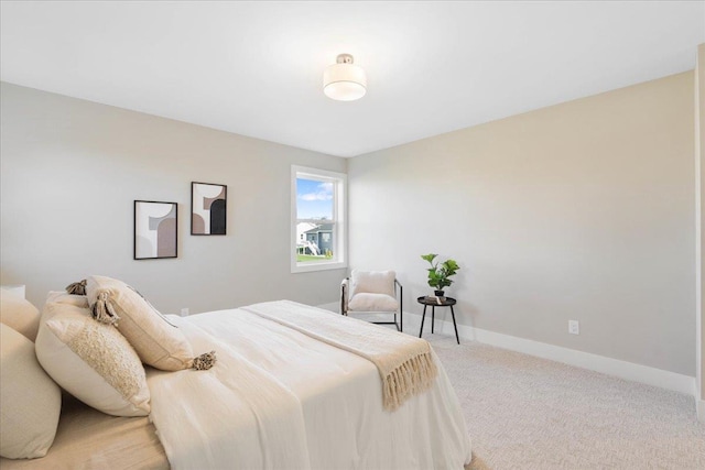 bedroom featuring baseboards and light carpet