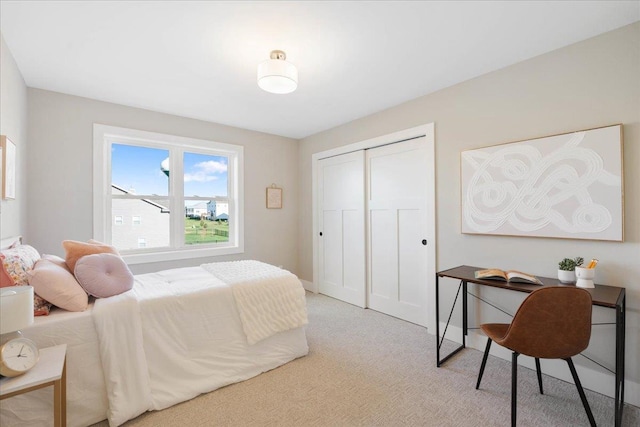 bedroom featuring a closet and light colored carpet