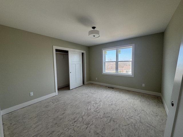 unfurnished bedroom featuring a closet, visible vents, and baseboards