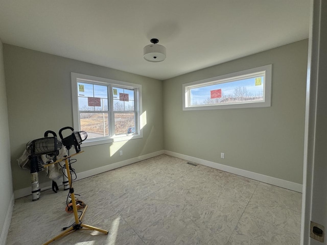 interior space with baseboards and visible vents