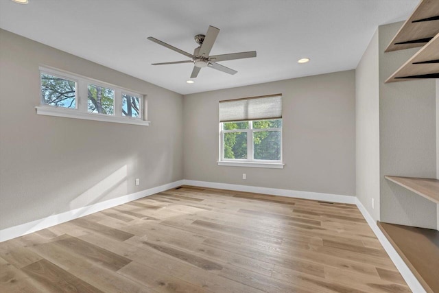 empty room with recessed lighting, baseboards, wood finished floors, and a ceiling fan