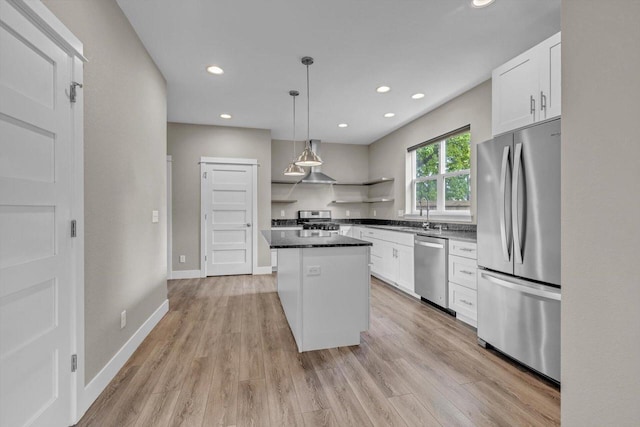 kitchen featuring open shelves, a kitchen island, appliances with stainless steel finishes, and white cabinetry