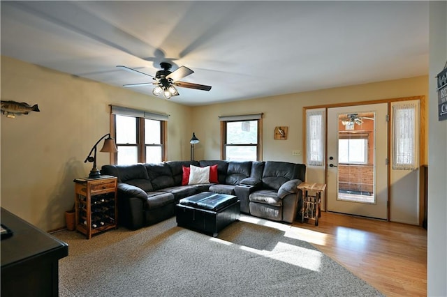 living room with wood finished floors and ceiling fan