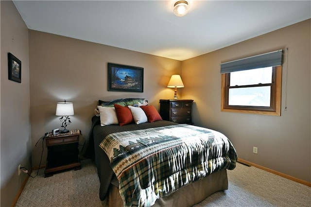 bedroom featuring baseboards and carpet