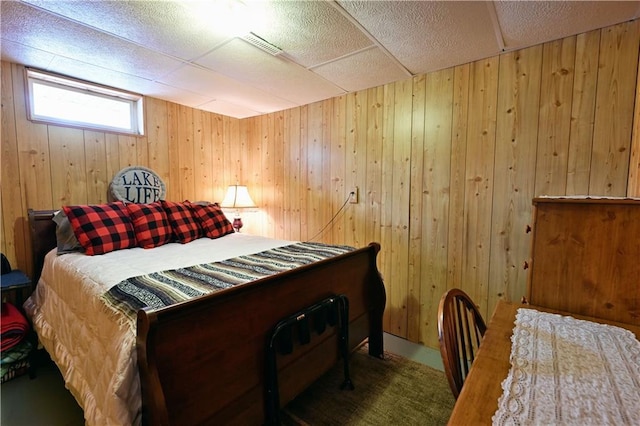 bedroom with visible vents and wooden walls