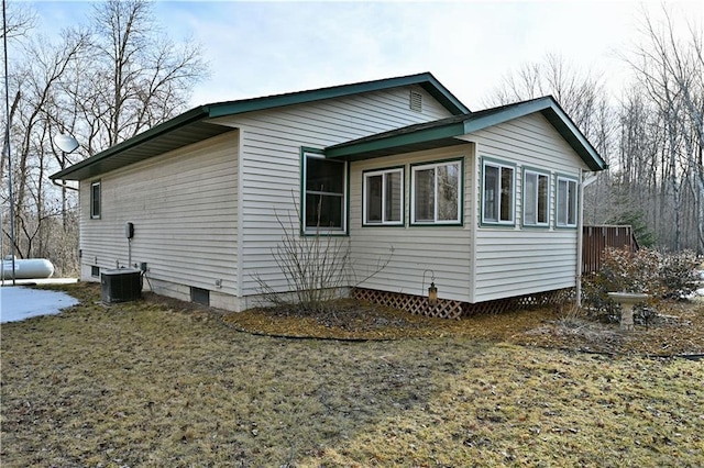 view of side of home with central air condition unit