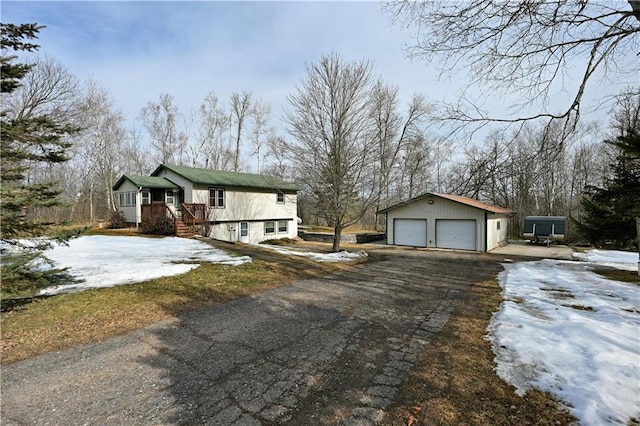 view of front facade with a garage and an outbuilding