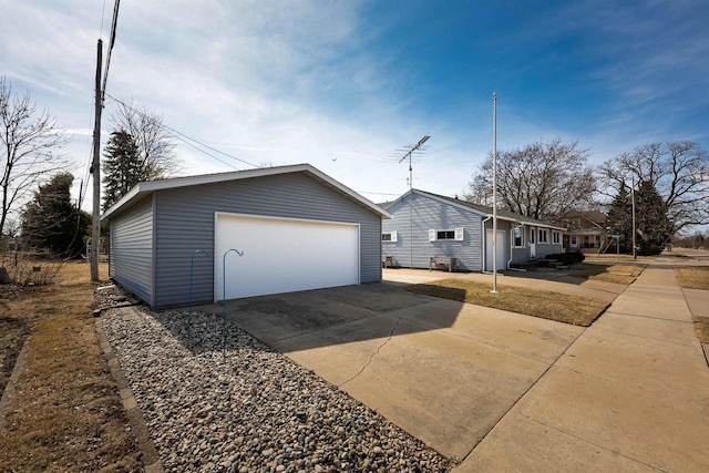 view of side of home featuring a detached garage and an outdoor structure