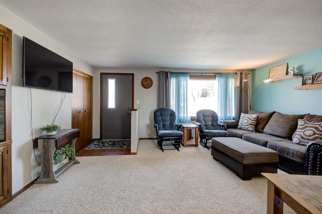 living room with carpet flooring, baseboards, and a textured ceiling