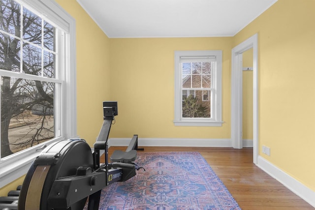 exercise area featuring baseboards and wood finished floors