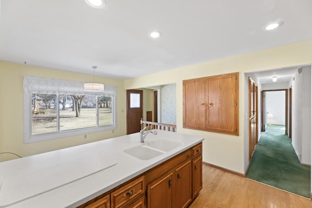 kitchen featuring a sink, light wood-style floors, recessed lighting, and light countertops