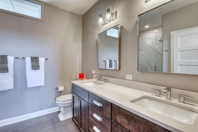 full bath with toilet, baseboards, a stall shower, and a sink