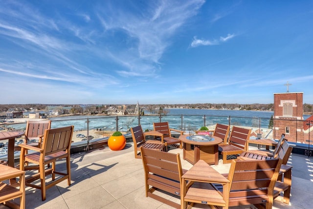 view of patio / terrace featuring a water view and an outdoor fire pit