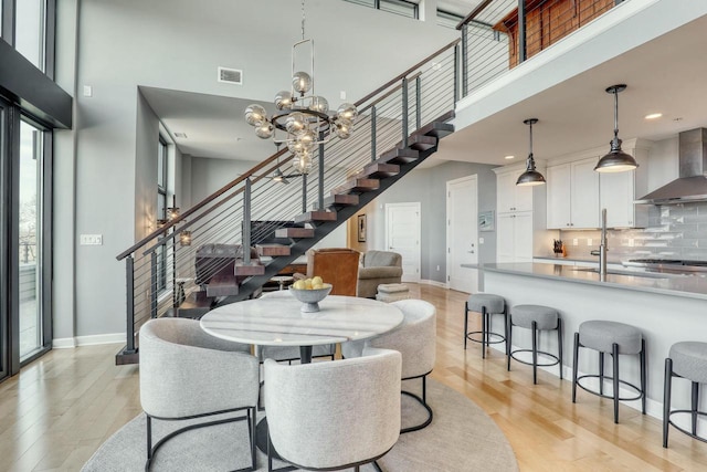 dining space with stairs and a high ceiling