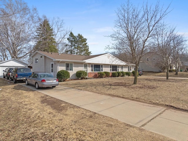 single story home with an outdoor structure and driveway