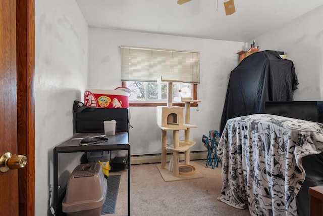 carpeted bedroom with baseboard heating and a ceiling fan