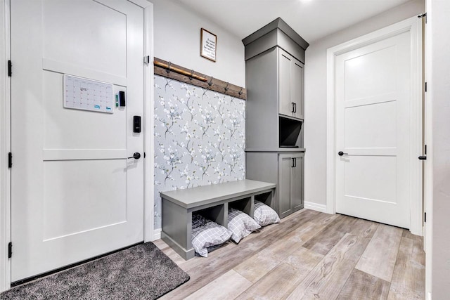 mudroom featuring light wood-style floors and baseboards