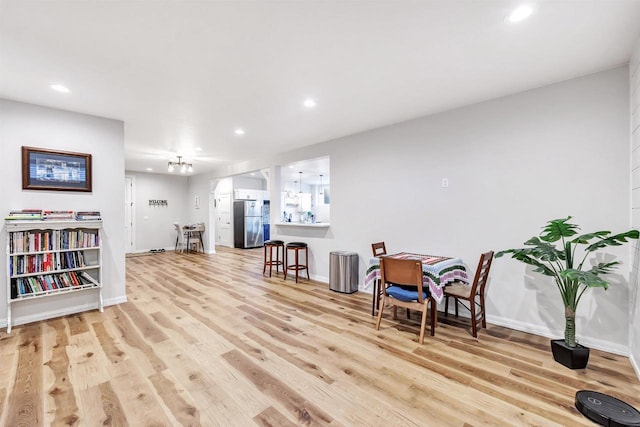 sitting room with light wood finished floors, recessed lighting, and baseboards