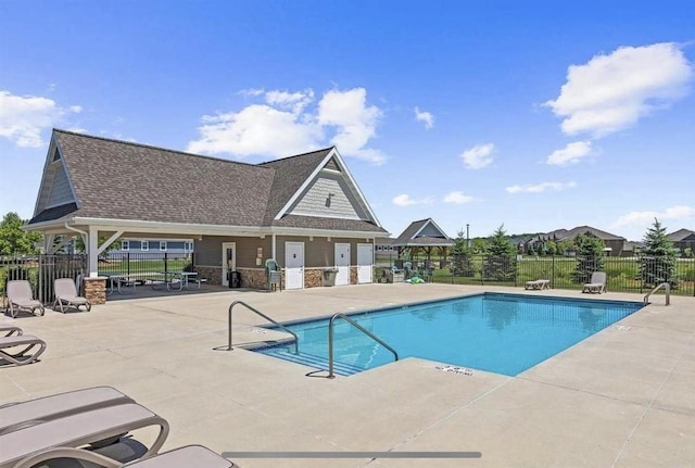 community pool with a patio and fence