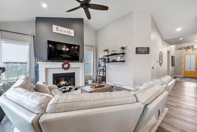 living room with visible vents, wood finished floors, plenty of natural light, and ceiling fan