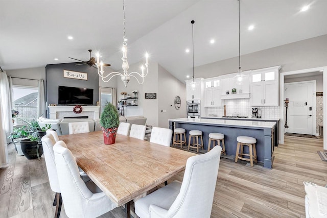 dining space featuring high vaulted ceiling, recessed lighting, light wood-style floors, and ceiling fan