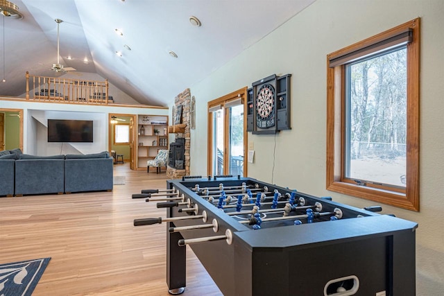 playroom with wood finished floors, a ceiling fan, and vaulted ceiling