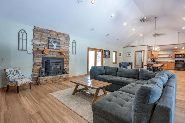 living room with baseboards, light wood finished floors, and high vaulted ceiling