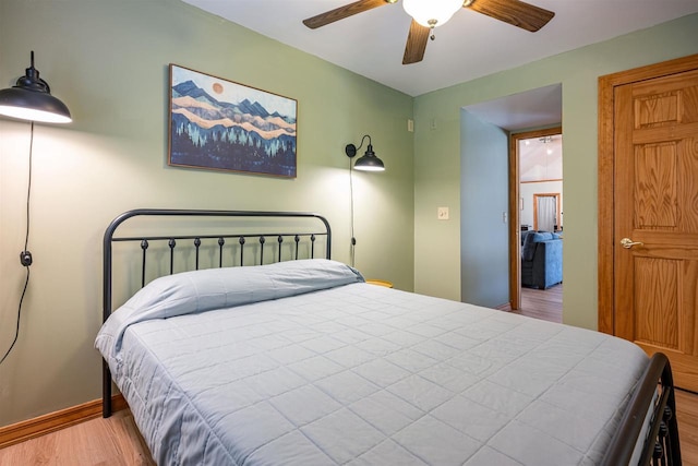 bedroom with baseboards, a ceiling fan, and wood finished floors