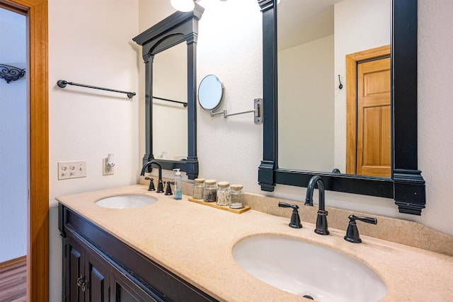 full bathroom with a sink and double vanity