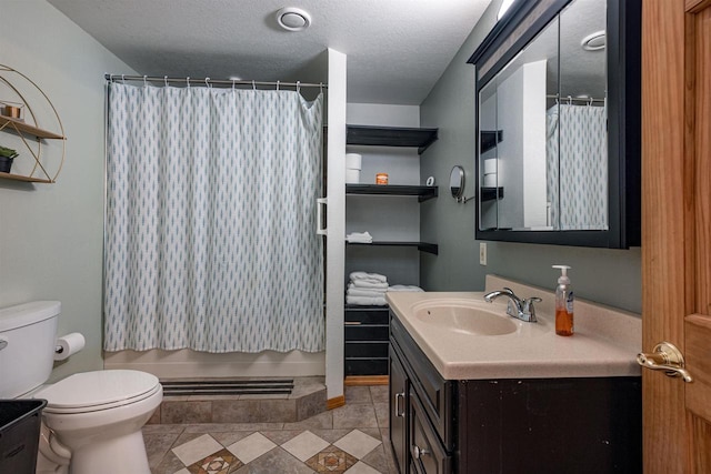 bathroom featuring toilet, a textured ceiling, and vanity