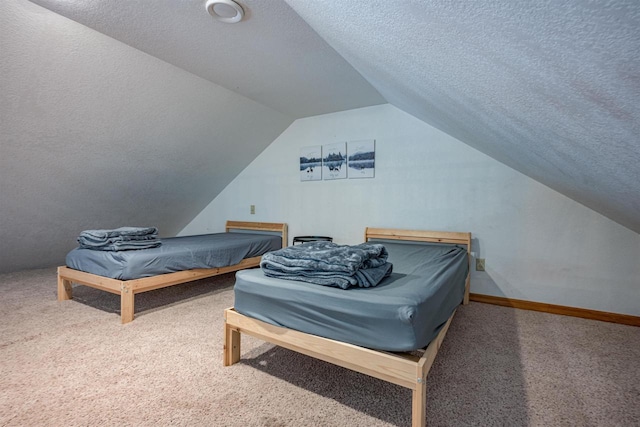 carpeted bedroom featuring baseboards, a textured ceiling, and lofted ceiling