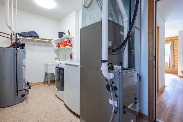 laundry area featuring washer and dryer, heating unit, gas water heater, baseboards, and laundry area