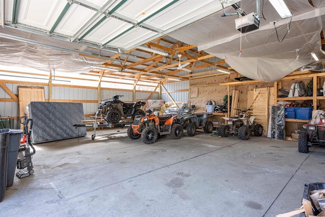 garage featuring metal wall and a garage door opener