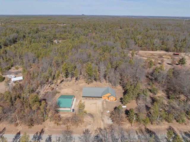 drone / aerial view with a wooded view