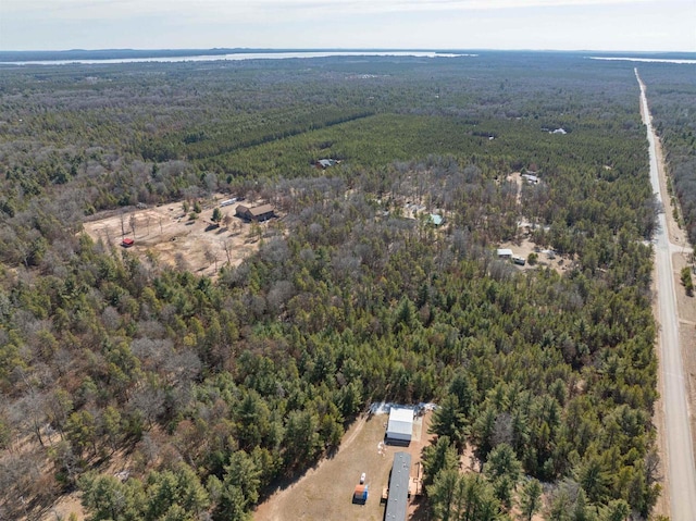 drone / aerial view with a wooded view