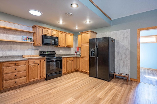 kitchen featuring light wood-type flooring, black appliances, open shelves, tasteful backsplash, and baseboards