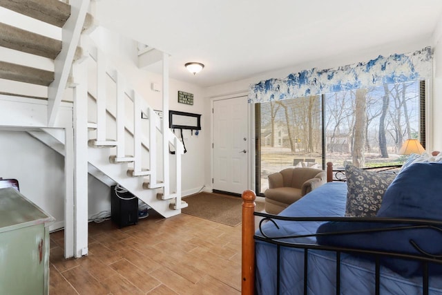 bedroom featuring baseboards and wood finish floors