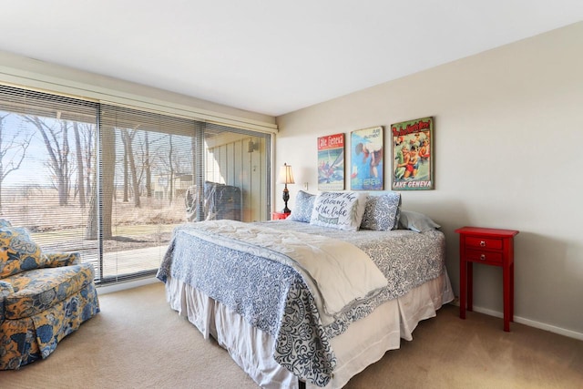 carpeted bedroom featuring baseboards