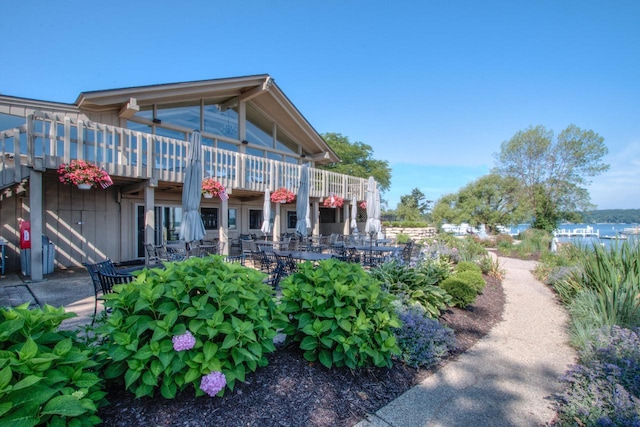 view of community featuring stairway, outdoor dining space, and a deck