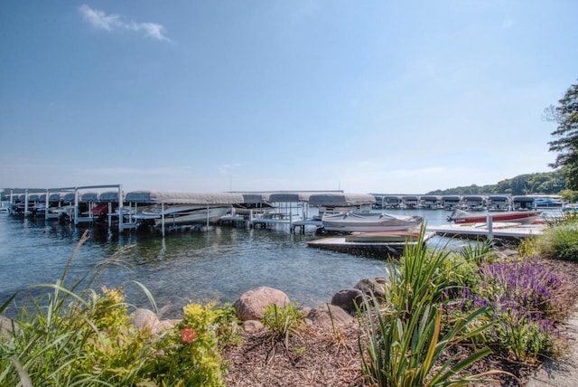 dock area with a water view and boat lift