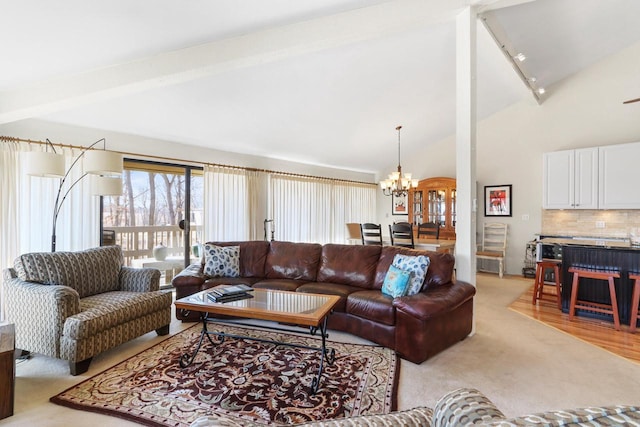 living room with a chandelier, beam ceiling, rail lighting, and high vaulted ceiling