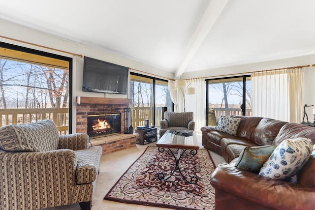 carpeted living room with a brick fireplace and vaulted ceiling with beams