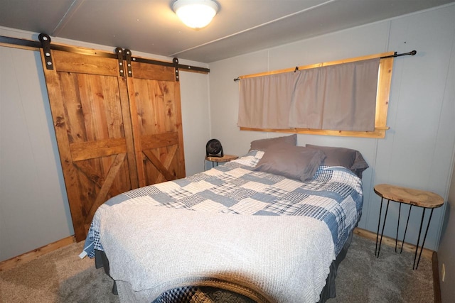 carpeted bedroom featuring a barn door