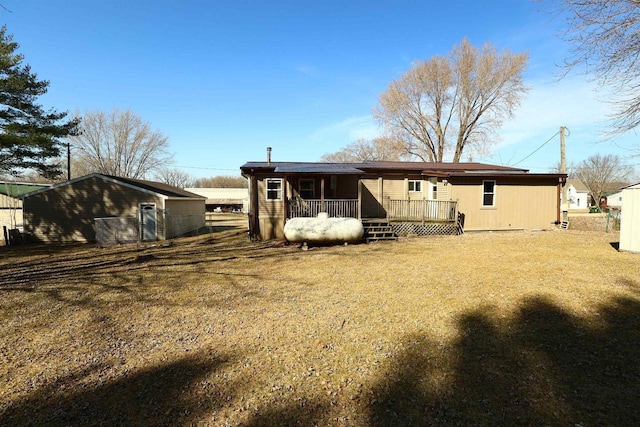 rear view of house featuring a yard