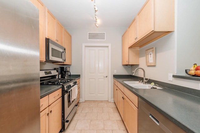 kitchen featuring a sink, visible vents, appliances with stainless steel finishes, and light brown cabinets