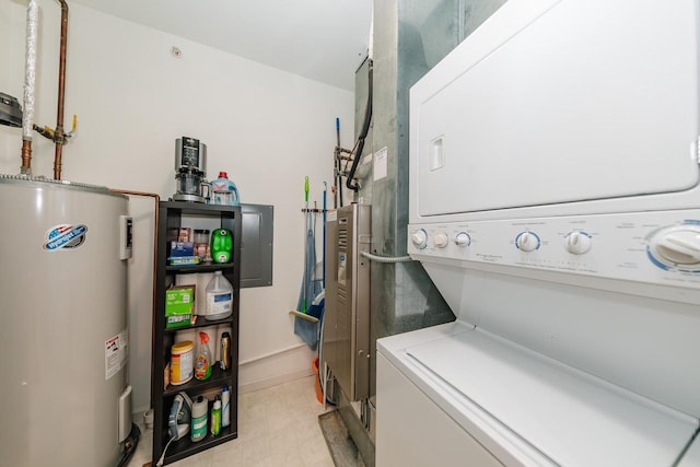 laundry room with laundry area, light floors, stacked washing maching and dryer, and electric water heater