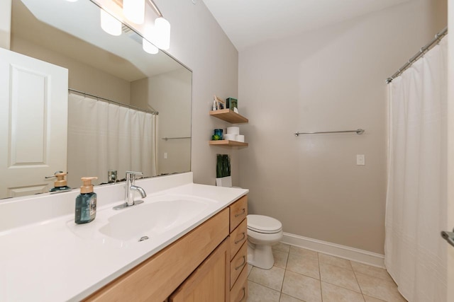 bathroom featuring tile patterned flooring, toilet, vanity, and baseboards