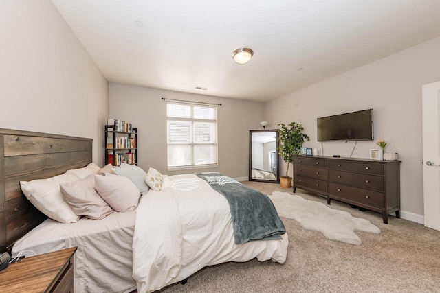 carpeted bedroom featuring visible vents and baseboards