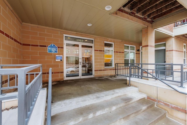 entrance to property with brick siding and covered porch