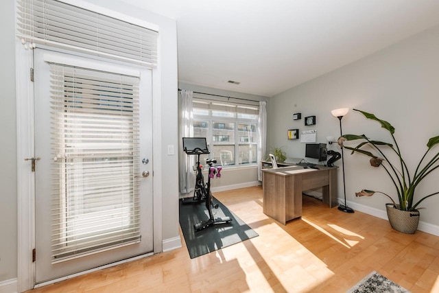 home office featuring visible vents, baseboards, and light wood-style floors